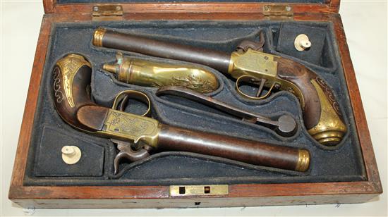 A cased pair of early 19th century brass mounted boxlock pistols, 10in., cased with brass powder horn